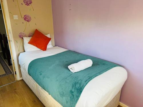 a bedroom with a bed with a towel on it at Contractors families free parking Ramsey Road in St Ives