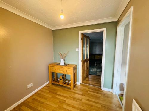 a room with a table with a vase on it at Contractors families free parking Ramsey Road in St Ives