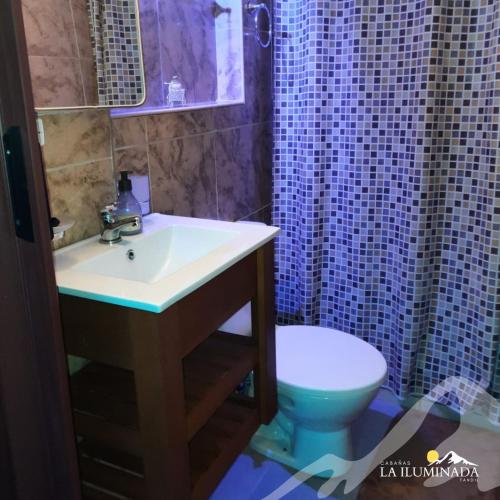 a bathroom with a sink and a toilet at Cabaña La iluminada in Tandil