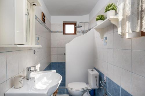 a bathroom with a sink and a toilet at Villa Ftenagia in Halki