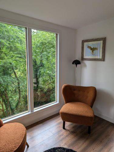 a living room with a chair and a window at Kestrel lodge in Wrexham