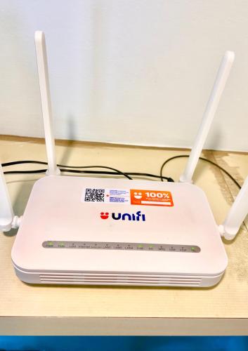 a white router sitting on top of a table at LEGOLAND with 10-15min drive from Bukit Indah Near Medini Nusajaya in Johor Bahru