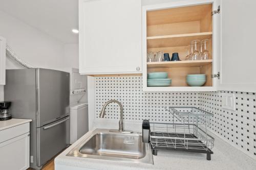 a kitchen with a sink and a refrigerator at Unit # 1 - Right Next to Howard University in Washington