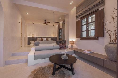 a living room with a bed and a table at Kantouni Lindos ELEGANT APARTMENT in Lindos