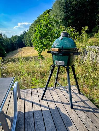 a grill on a stand on a wooden deck at Wald-Hotel Heppe in Dammbach