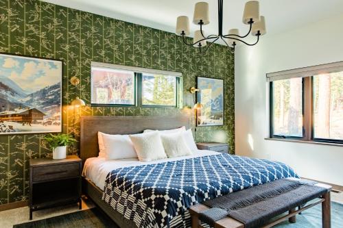 a bedroom with a bed and green wallpaper at 5 King Beds! Golf Course View on Huge Shaded Deck in Cle Elum