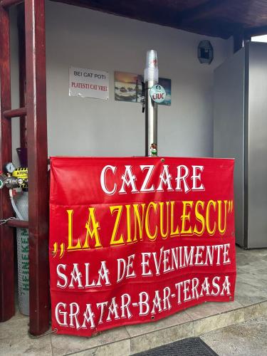 a red sign that says square la zancayss sidx sidx sidx at La Zinculescu in Albeştii Pămînteni