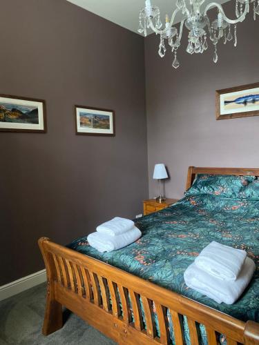 a bedroom with a bed with two pillows on it at Cumberland House in Cockermouth