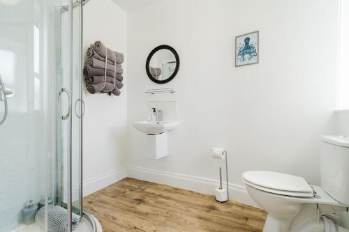 a bathroom with a toilet and a sink and a shower at The Roxburgh Guest Accommodation in Berwick-Upon-Tweed