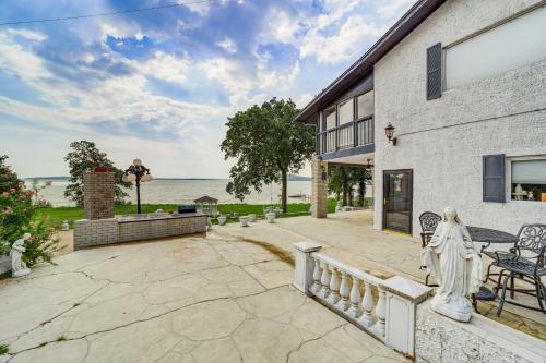 a patio with a statue in front of a building at Lakefront Eufaula Escape with Dock and Private Beach! in Eufaula