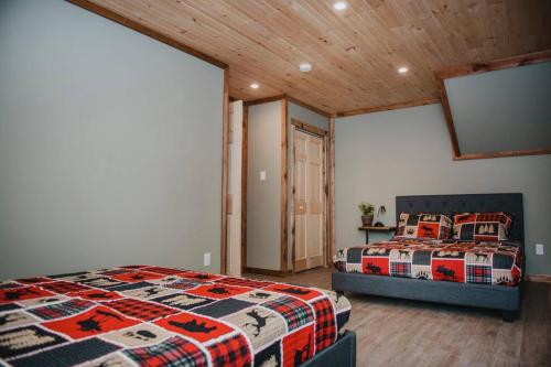 a bedroom with two beds and a large window at Lux waterfront all inclusive on Ottawa River in Bryson