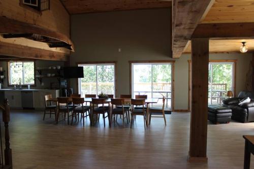 a dining room with a table and chairs at Lux waterfront all inclusive on Ottawa River in Bryson