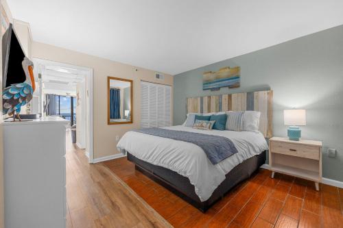 a bedroom with a bed and a table with a lamp at Stunning 1 Bedroom Condo-Breathtaking Oceanfront Views-Meridian 602 in Myrtle Beach