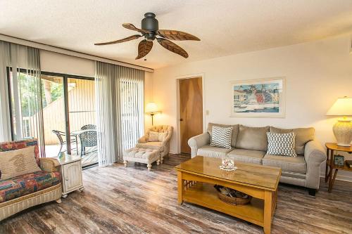 a living room with a couch and a table at Hibiscus H204 in St. Augustine