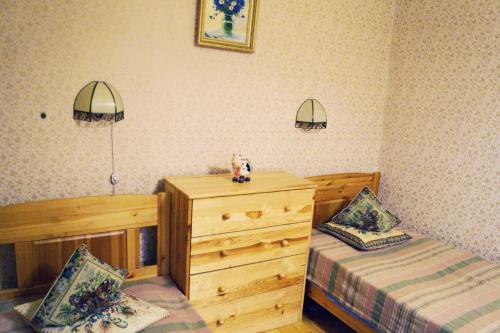 a bedroom with two twin beds and a dresser at Апартаменты Бутусовские in Yaroslavl