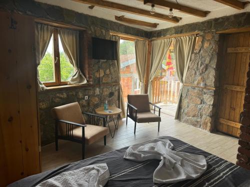 a bedroom with a bed and a table and chairs at Villa Old House BN in Bitola