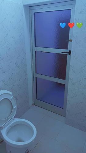 a bathroom with a toilet and a door with hearts on it at booking love in Yof