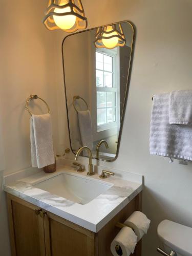 a bathroom with a sink and a large mirror at The Beacon in Salter Path