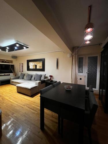 a living room with a couch and a table at GOA Apartament central - plajă in Constanţa
