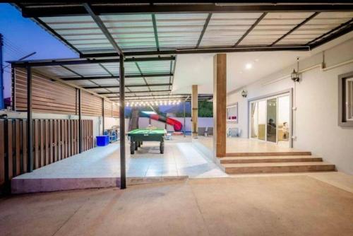 a garage with a pool table and a playground at Huahin Friends Pool Villa 1 in Hua Hin