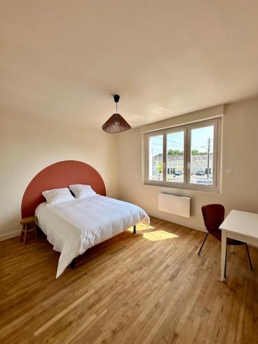 a bedroom with a large bed and a window at Charmante Maison avec Terrasse in Angers