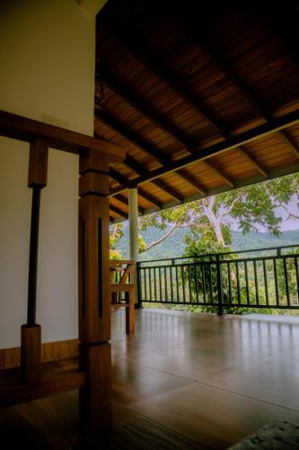 a view from the inside of a house with a balcony at Evergreen Villa - Sinharaja in Deniyaya