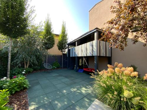 a garden with a house with a patio at Salt Garden Superior double rooms in Druskininkai