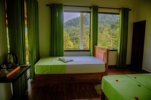a bedroom with a bed and a window with green curtains at Evergreen Villa - Sinharaja in Deniyaya