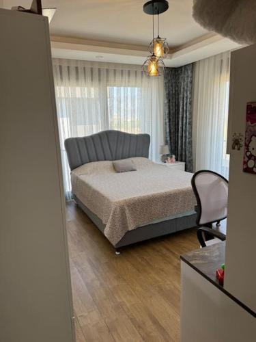 a bedroom with a bed and a chair in it at Misafirlerin favorisi Villa naz in Dosemealti
