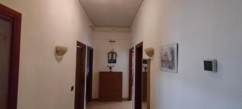 a hallway with white walls and a room with two doors at Appartamento Rialdoli in Scandicci