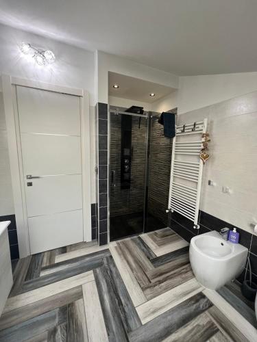 a bathroom with a shower and a toilet and a sink at La finestra su Torino in Orbassano