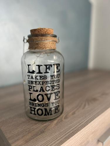 a glass jar with writing on it sitting on a table at La finestra su Torino in Orbassano
