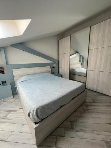 a bedroom with a large bed in a room at La finestra su Torino in Orbassano