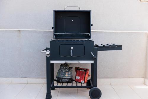 a charcoal grill on a cart in a room at The Roof Top - By Solea in Ħal Balzan