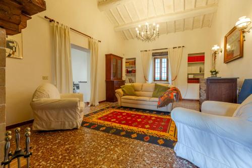 a living room with two chairs and a couch at Podere del Monte in Amelia