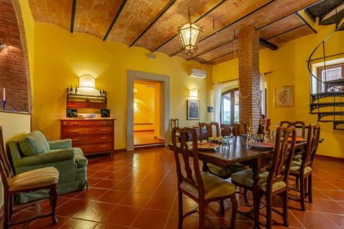 a dining room with a table and chairs at Podere del Monte in Amelia