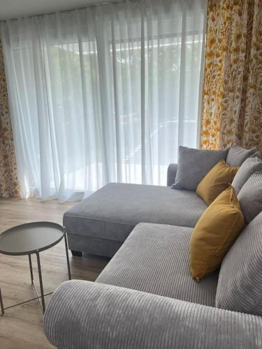 a living room with a couch and a table at Neue Unterkunft mit Terrasse und TG-Stellplatz in Sindelfingen