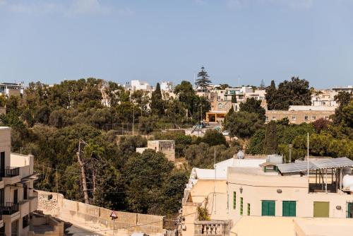 a view of a city with buildings and trees at The Roof Top - By Solea in Ħal Balzan