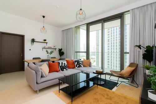 a living room with a couch and a table at Elite Escape - 1 BHK Getaway Dubai Mall Access - 1509 in Dubai