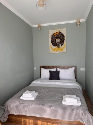 a bedroom with a bed with towels on it at Guesthouse Relax in Kazbegi in Stepantsminda