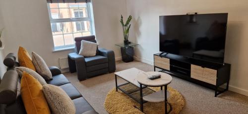 a living room with a large flat screen tv at The Grace House Entire 4bed detached in Peterborough