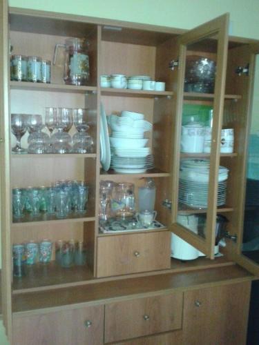 a cabinet filled with plates and bowls and glasses at Pasidu Villa in Kalutara