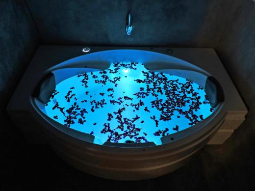 a bath tub with a blue light in it at Villa Ecotiva in Puducherry