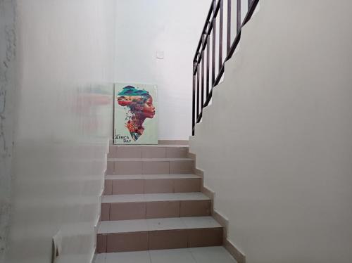 a staircase in a white wall with a stair case at Villa Arsdou in Ségbé