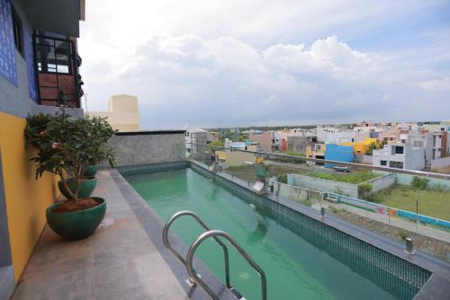 a swimming pool on the roof of a building at Villa Ecotiva in Puducherry
