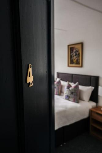 a door with a number four on it next to a bed at Lake House & Private Pub Kerry - Large Groups up to 26 People in Kenmare