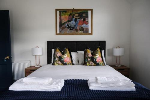 a bedroom with a bed with two towels on it at Lake House & Private Pub Kerry - Large Groups up to 26 People in Kenmare