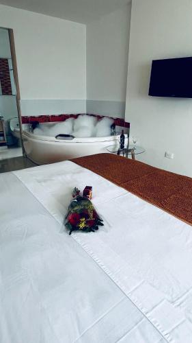 a room with a bed with a white blanket at Hotel Cabreromar in Cartagena de Indias