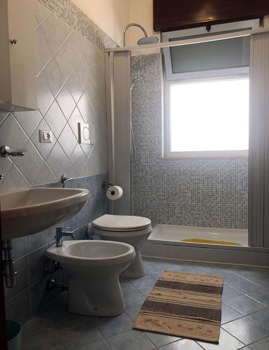 a bathroom with a toilet and a sink and a tub at Odegos Residence Torre dell'Orso in Torre dell'Orso