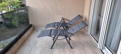 a chair sitting on top of a balcony at Summer Park Residence Peljesac in Orebić